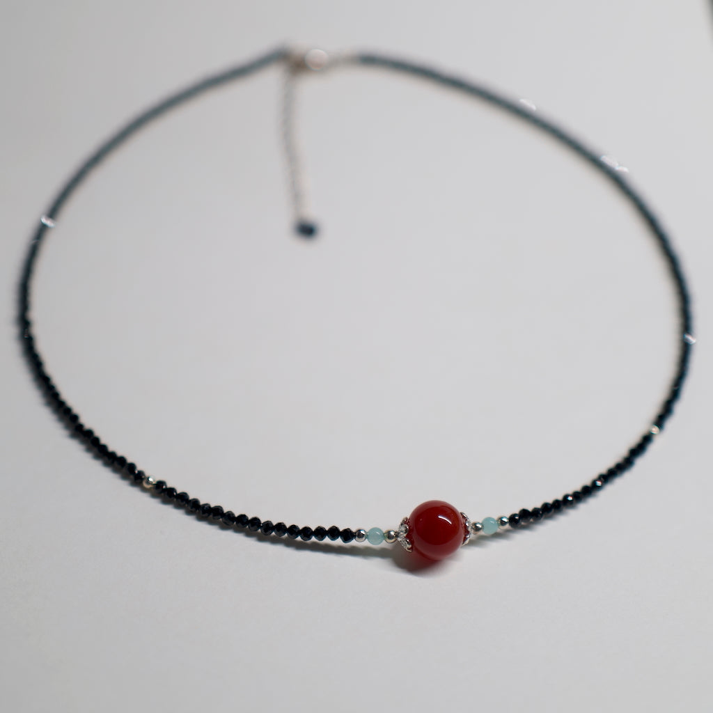 AuroraGems black beaded necklace with red Abundance Crystal bead and silver accents by archeast
