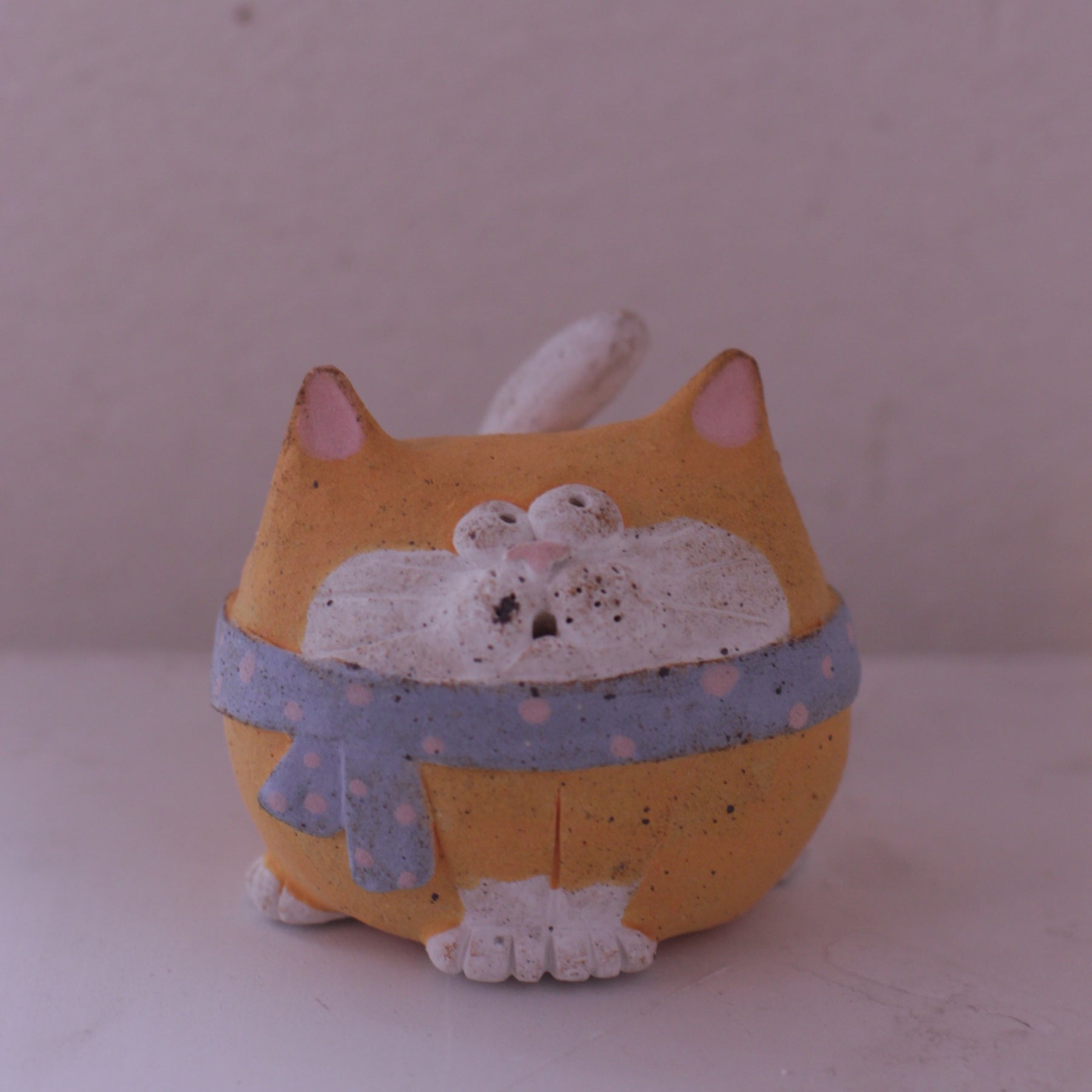 Handmade Clay Cat Figurine with orange body and blue scarf by various artists