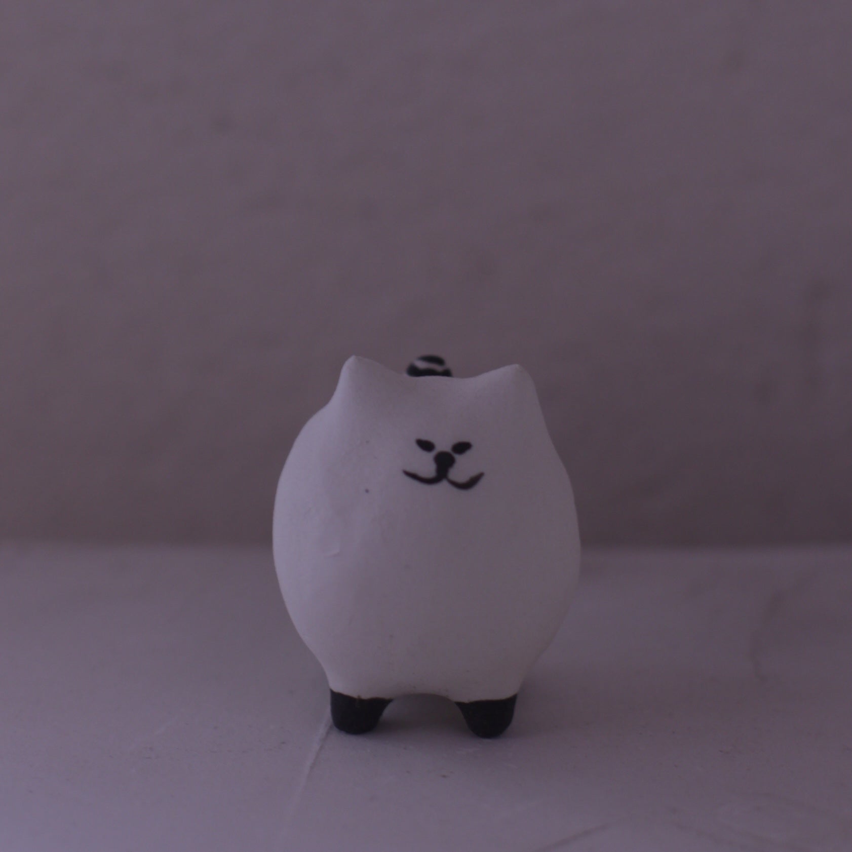 Handmade clay cat figurine pottery in white with black facial features and paws by various artist