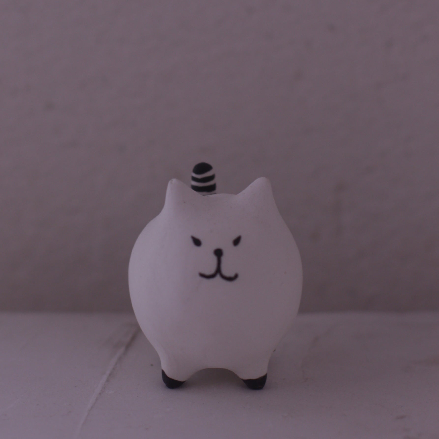 Handmade Clay Cat Figurine with minimalist design and black striped tail by various artist