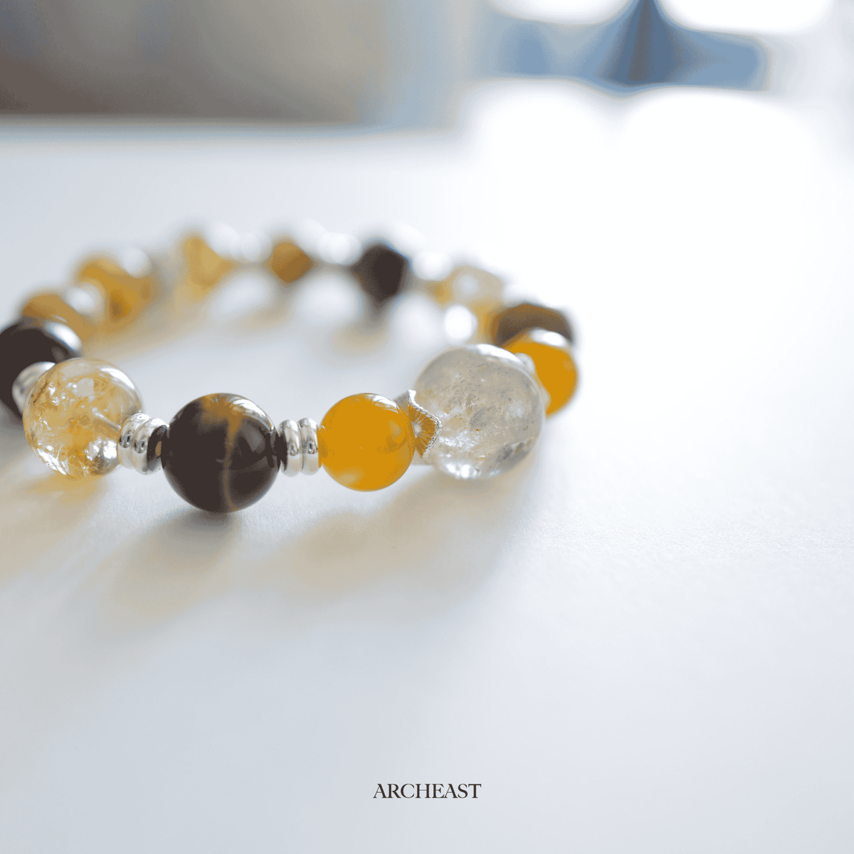 AuroraGems tiger's eye energy bracelet by archeast with polished yellow and brown beads on white background