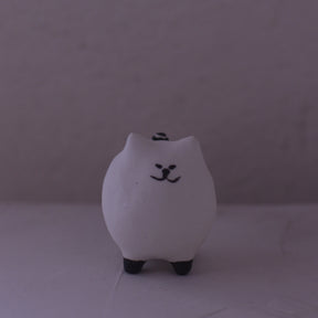 Handmade clay cat figurine pottery in white with black facial features and paws by various artist