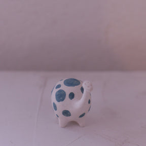Handmade pottery animal figurine with white body and blue spots crafted by various artist