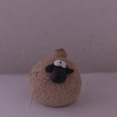 Handmade pottery animal figurine of a round sheep with textured body and black face