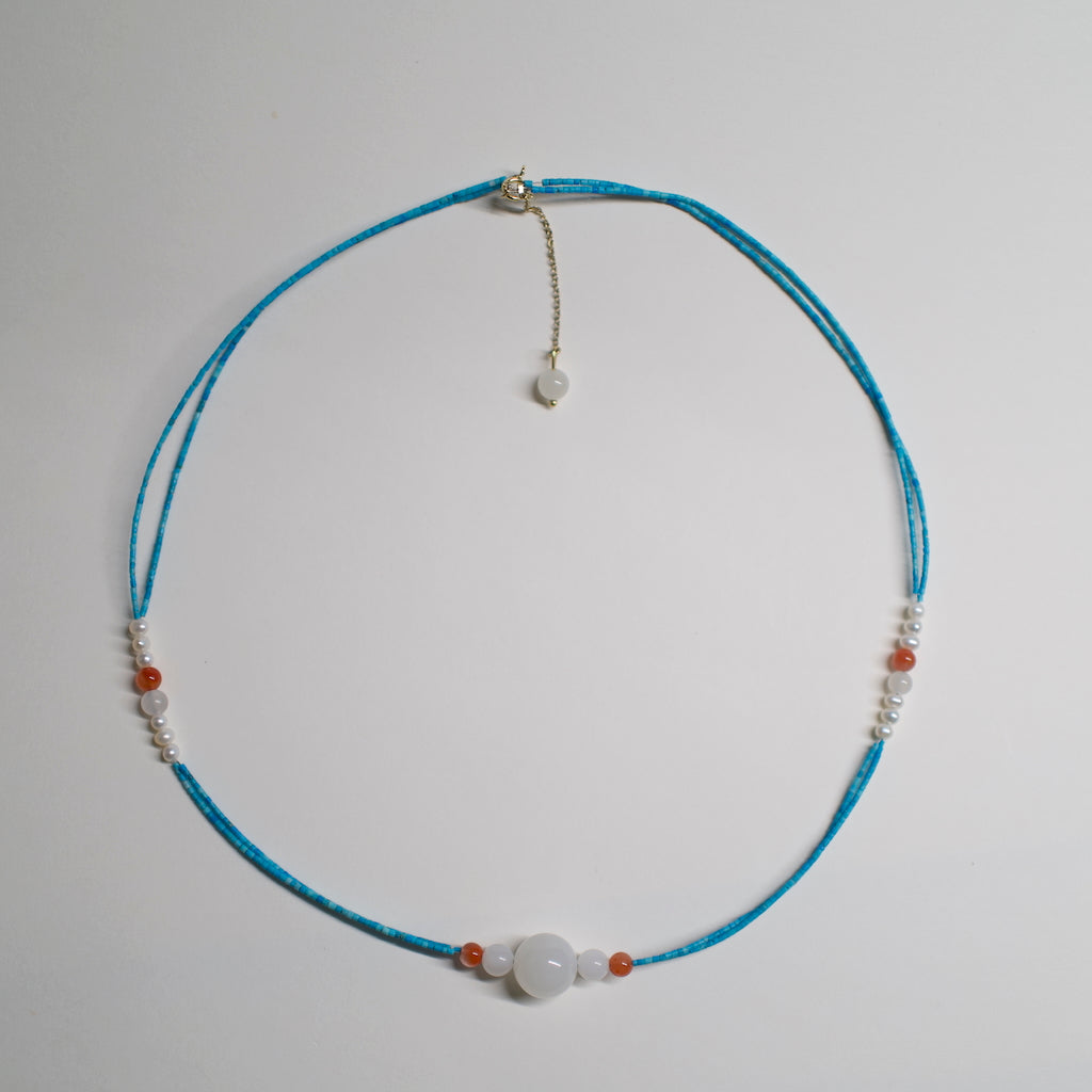 Turquoise Necklace by ARCHEAST with white and orange beads showcasing a minimalist design