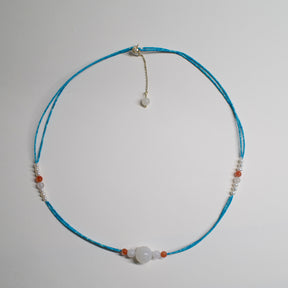 Turquoise Necklace by ARCHEAST with white and orange beads showcasing a minimalist design